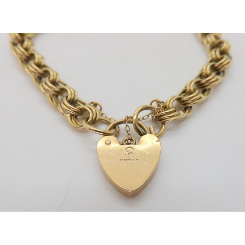 582 - A 9ct gold fancy link bracelet with heart shaped clasp, length 16.5cm, weight 11.6gms