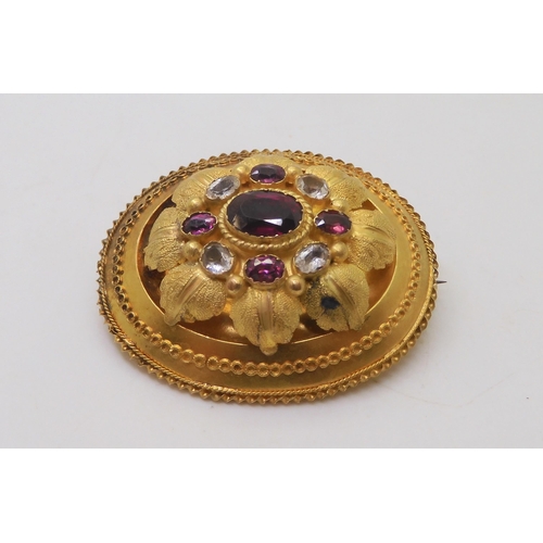 588 - A yellow metal Victorian brooch set with garnets and rock crystal, weight 6.5gms