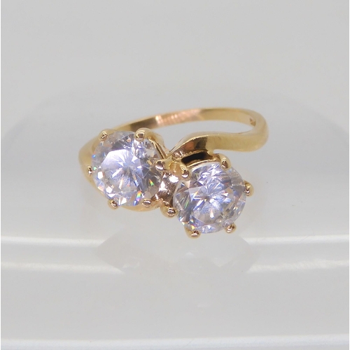 589 - A 14k gold twin cz ring, size O1/2, weight 4.8gms