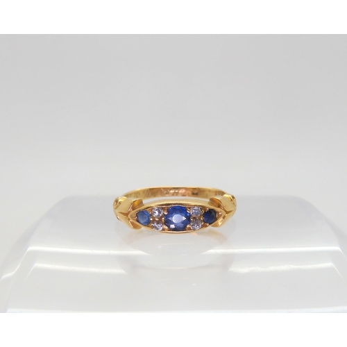 596 - A bright yellow metal ring, set with sapphires and diamonds, inscribed to the inner shank dates 1904... 