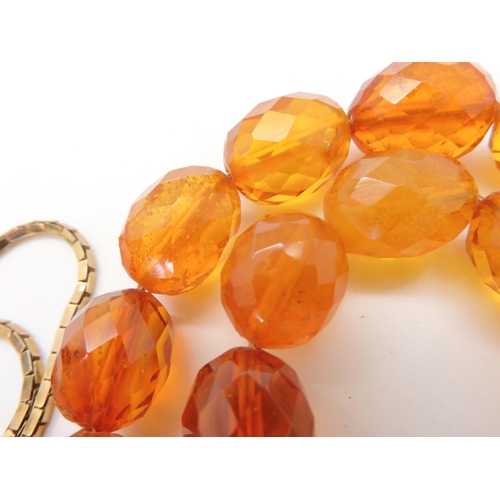 667 - A string of amber coloured beads, weight 94.1gms approx, together with a silver Mackintosh style pen... 