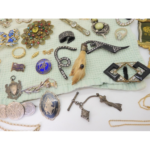 668 - A collection of vintage costume brooches, silver and white metal jewellery to include a Pontin's bro... 