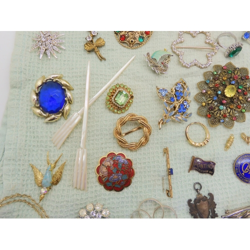 668 - A collection of vintage costume brooches, silver and white metal jewellery to include a Pontin's bro... 