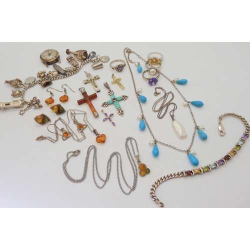 676 - A collection of silver and gemstone crosses, a silver charm bracelet with fifteen silver and white m... 