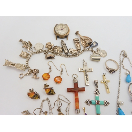 676 - A collection of silver and gemstone crosses, a silver charm bracelet with fifteen silver and white m... 