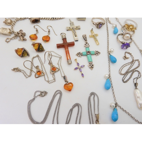 676 - A collection of silver and gemstone crosses, a silver charm bracelet with fifteen silver and white m... 