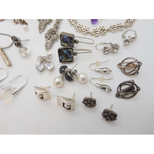 680 - A collection of silver and costume jewellery to include Mackintosh style items, silver bangles, desi... 