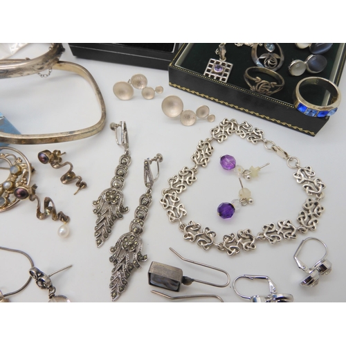 680 - A collection of silver and costume jewellery to include Mackintosh style items, silver bangles, desi... 