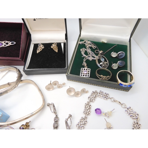 680 - A collection of silver and costume jewellery to include Mackintosh style items, silver bangles, desi... 