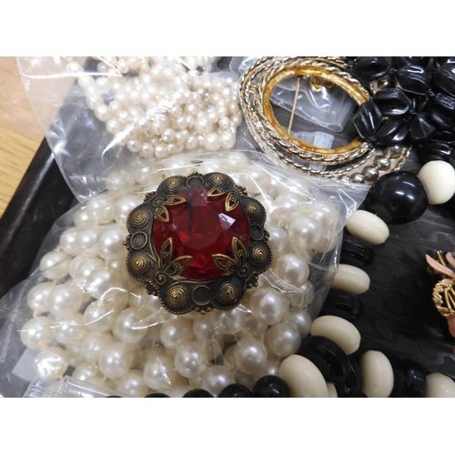 700 - A large collection of vintage costume jewellery to include, pearls, vintage beads, brooches a souven... 