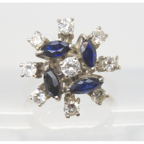 2801 - A RETRO SAPPHIRE & DIAMOND CLUSTER RINGset throughout in white metal, the four blue marquis cut ... 