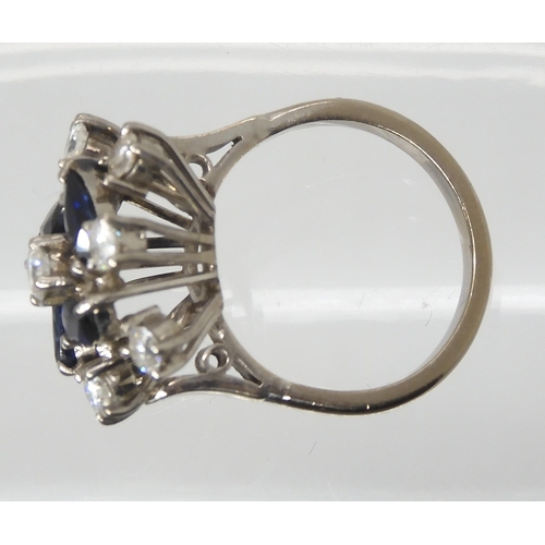 2801 - A RETRO SAPPHIRE & DIAMOND CLUSTER RINGset throughout in white metal, the four blue marquis cut ... 