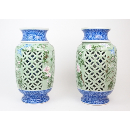 2355 - A PAIR OF JAPANESE CELADON RETICULATED VASESeach moulded in relief and painted with birds and foliag... 