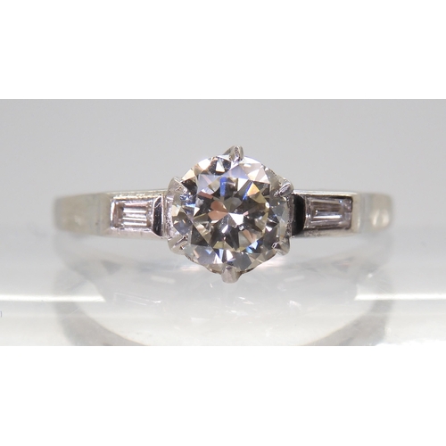 2703 - A CLASSIC VINTAGE DIAMOND RINGset with an estimated approx 0.58ct brilliant cut diamond, with furthe... 