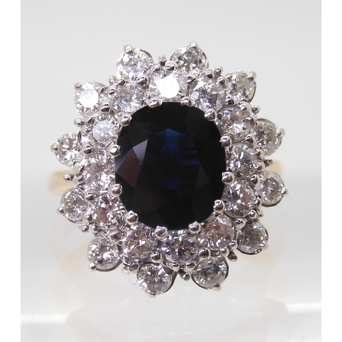 2721 - A SAPPHIRE AND DIAMOND CLUSTER RINGthe 16.8mm x 18mm cluster, mounted throughout in yellow and white... 