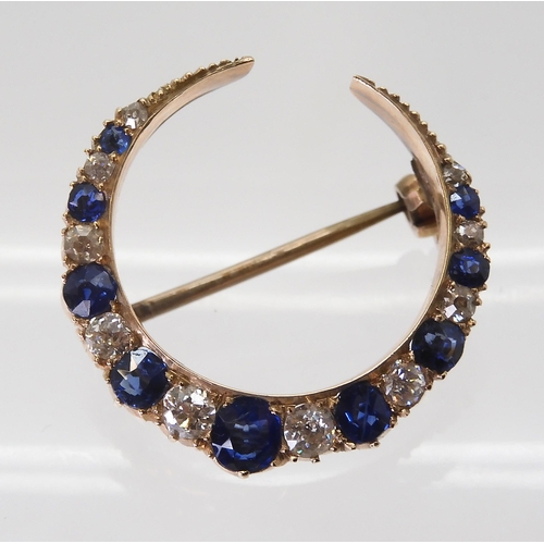 2735 - A SAPPHIRE & DIAMOND MOON BROOCHset throughout in yellow metal with galleried mount, in original... 