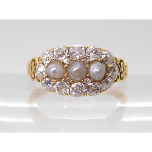 2765 - A PEARL AND OLD CUT DIAMOND RINGwith a pretty pierced gallery and shoulders in 18ct gold, set with e... 