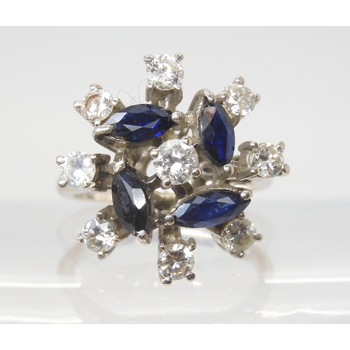 2801 - A RETRO SAPPHIRE & DIAMOND CLUSTER RINGset throughout in white metal, the four blue marquis cut ... 