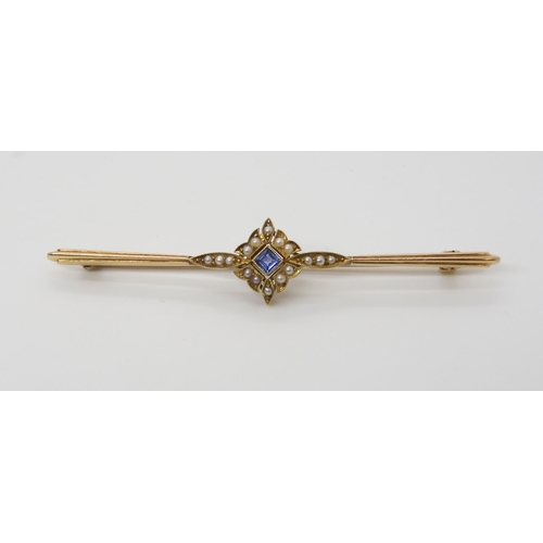 2803 - A 15CT PEARL AND BLUE GEM BROOCHthe millgrain flower setting is set with split pearls and a blue gem... 