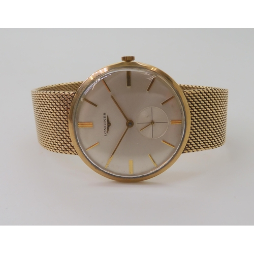 2904 - A 9CT GOLD GENTS LONGINES WATCHwith integral woven strap, a silvered dial, gold baton numerals and s... 