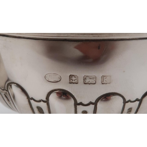 409 - A collection of silver including a footed silver bowl, Birmingham 1934, the body partly fluted, a si... 