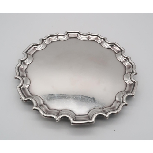 410 - An Elizabeth II silver salver, of shaped form, with a chippendale style piecrust edge, by Laings Ltd... 