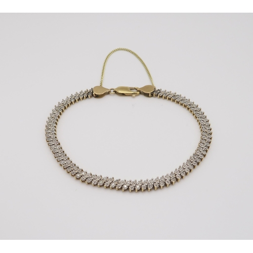 602 - A 9ct gold diamond accent bracelet in a lacy pattern, length 20.5cm, weight 10.1gms