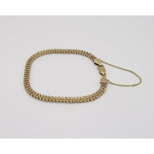 602 - A 9ct gold diamond accent bracelet in a lacy pattern, length 20.5cm, weight 10.1gms