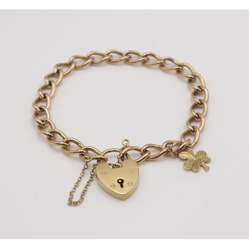 611 - A 9ct rose gold curb link chain with heart shaped clasp and shamrock charm, length 17cm, weight 15.6... 