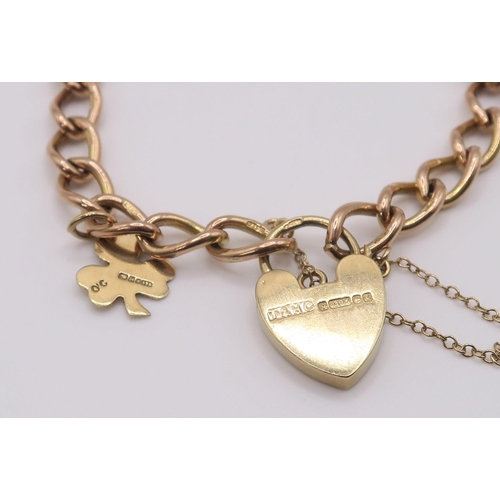 611 - A 9ct rose gold curb link chain with heart shaped clasp and shamrock charm, length 17cm, weight 15.6... 