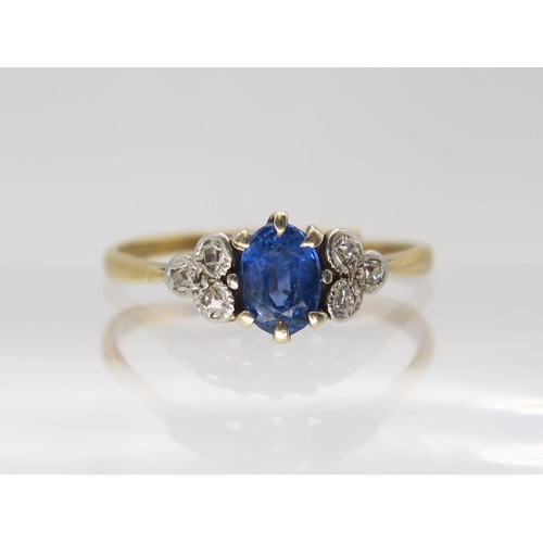 642 - A bright yellow metal sapphire and diamond ring, the central sapphire is approx 5.5mm x 4.3mm x 2.7m... 