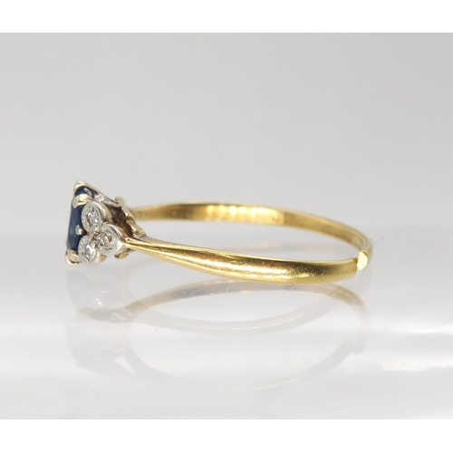 642 - A bright yellow metal sapphire and diamond ring, the central sapphire is approx 5.5mm x 4.3mm x 2.7m... 