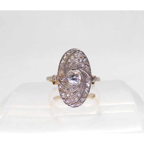 A vintage diamond panel ring, with a milgrain swirl design, mounted in bright yellow and white metal, and set with estimated approx 0.40cts of old cut and rose cut diamonds, (0.30cts are old cuts) size of the plaque 19mm x 10.8mm, finger size O1/2, weight 2.8gms