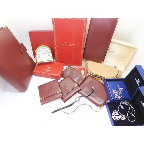 A collection of Cartier leather goods to include wallets purses