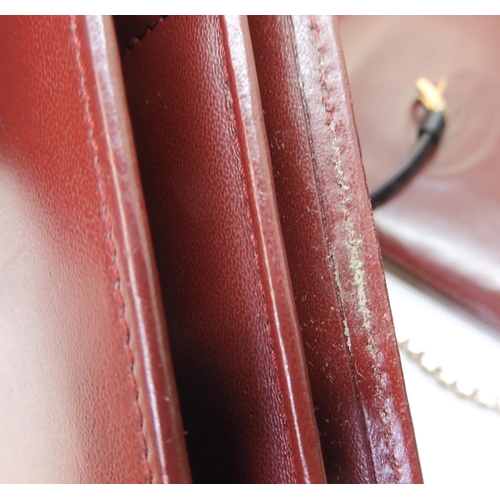 A collection of Cartier leather goods to include wallets purses