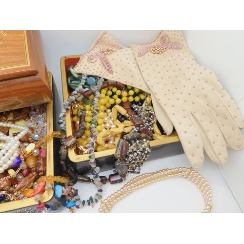 800 - A pair of vintage evening gloves, a marquetry jewel box filled with beads,  costume jewellery etc