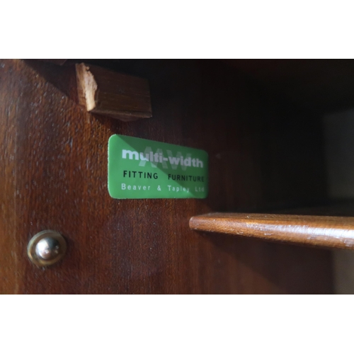 112 - A mid 20th century stained teak bureau with fall front writing compartment over sliding doors, 101cm... 