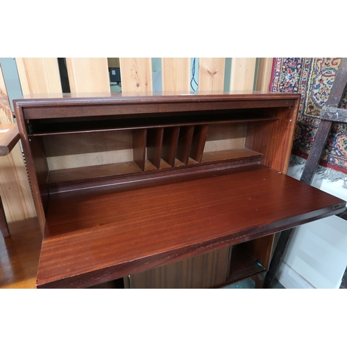 112 - A mid 20th century stained teak bureau with fall front writing compartment over sliding doors, 101cm... 