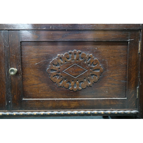 123 - A 20th century stained oak dresser with two long drawers over cabinet doors on turned supports, 79cm... 