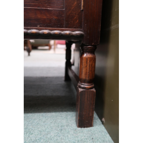 123 - A 20th century stained oak dresser with two long drawers over cabinet doors on turned supports, 79cm... 