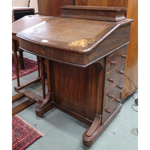 127 - A Victorian walnut Davenport desk with hinged top stationary compartment over embossed skiver over f... 