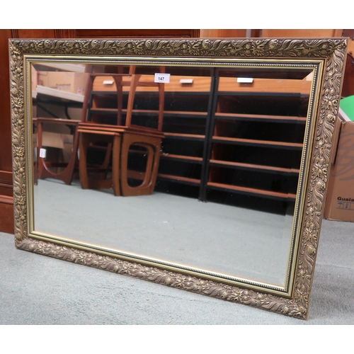 147 - A contemporary gilt framed wall mirror with bevelled glass mirror pane, 62cm high x 87cm wide