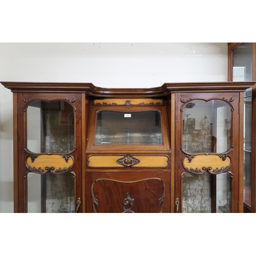 159 - A 20th century mahogany art nouveau style display cabinet with shaped top over central glazed fall f... 