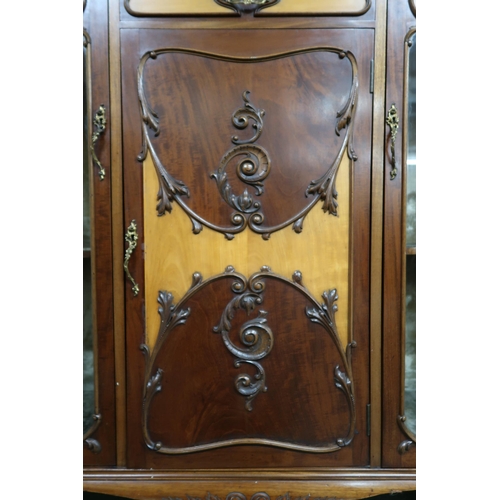 159 - A 20th century mahogany art nouveau style display cabinet with shaped top over central glazed fall f... 