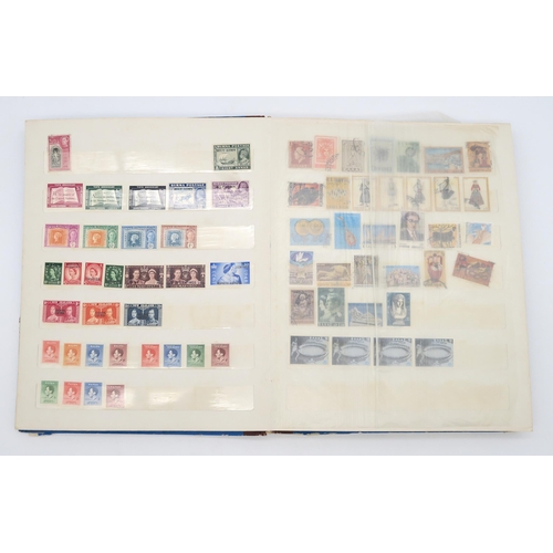 497 - STAMPS a collection of stamps in albums with mixed British, colonies to include Malta, Jamaica, Nata... 