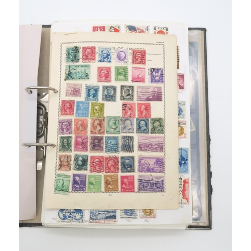 497A - A collection of USA stamps, with various commemorative and older examples, housed in a ring-bound fo... 