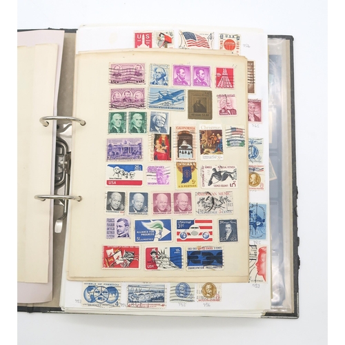 497A - A collection of USA stamps, with various commemorative and older examples, housed in a ring-bound fo... 