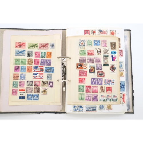 497A - A collection of USA stamps, with various commemorative and older examples, housed in a ring-bound fo... 