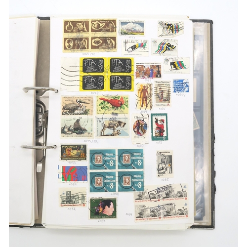 497A - A collection of USA stamps, with various commemorative and older examples, housed in a ring-bound fo... 