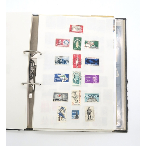 497A - A collection of USA stamps, with various commemorative and older examples, housed in a ring-bound fo... 